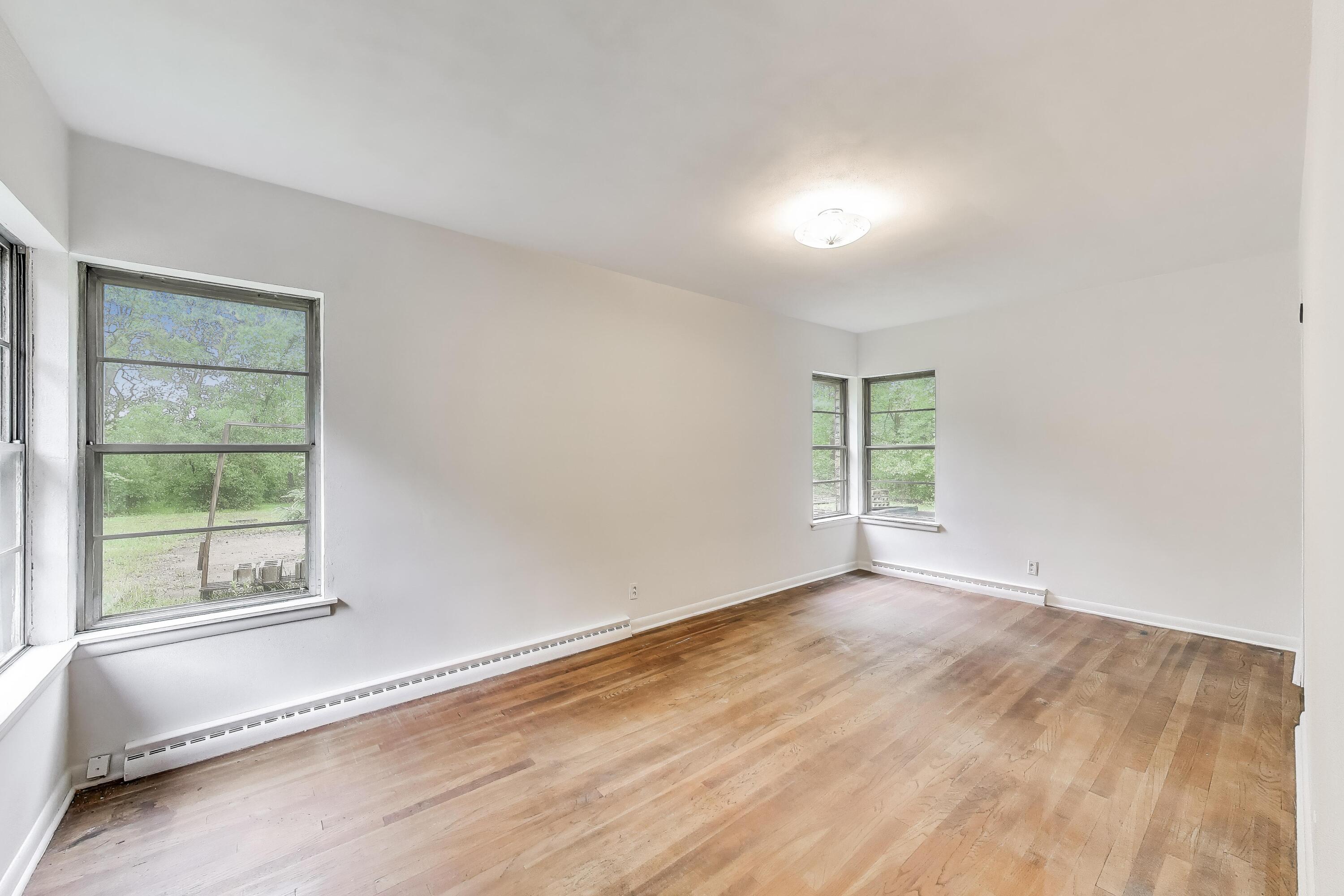 451 Johnson Road Trail Creek, IN 46360 - Photo 32 of 55 an empty room with wooden floor and windows