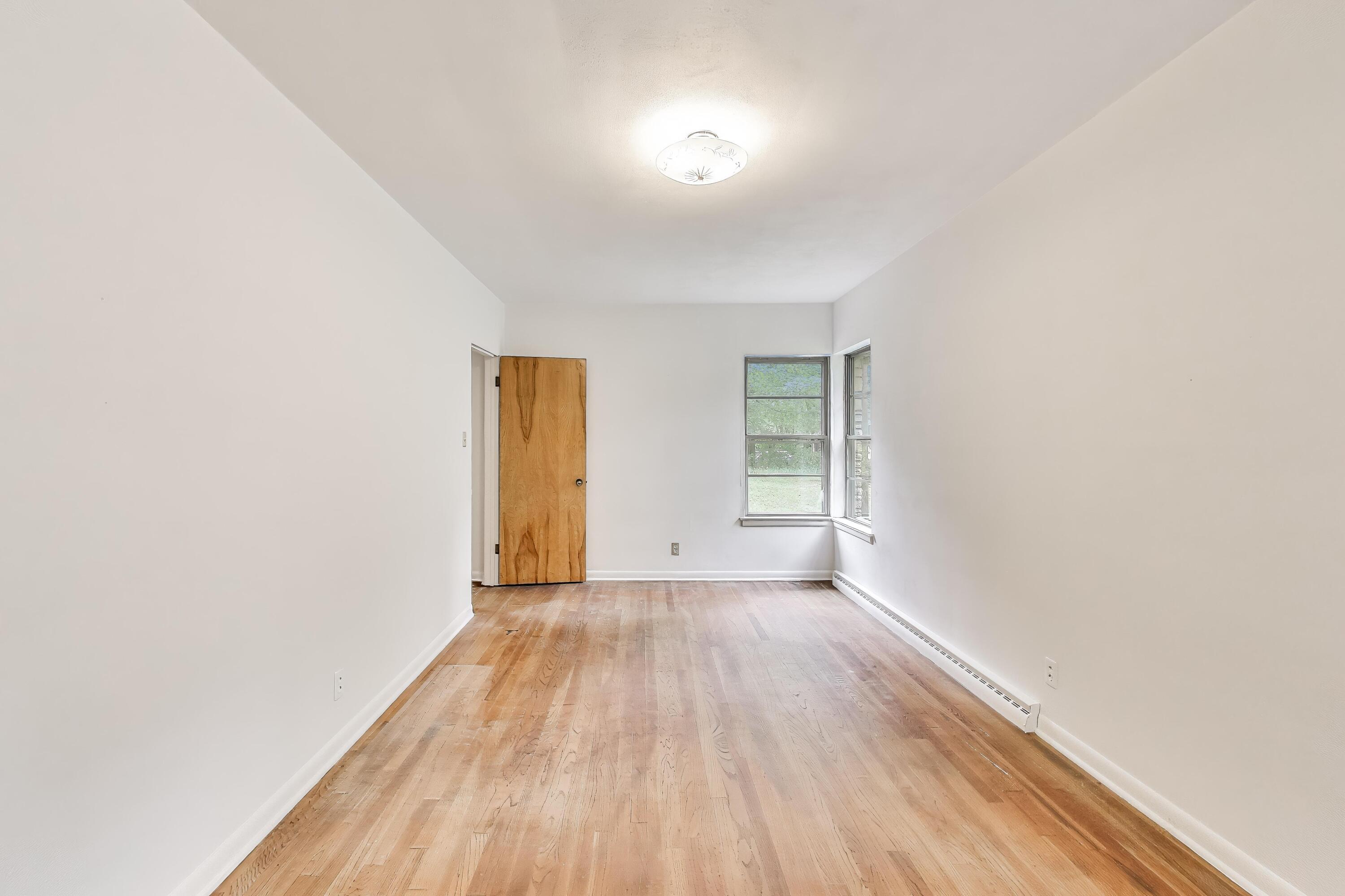 451 Johnson Road Trail Creek, IN 46360 - Photo 33 of 55 an empty room with wooden floor and windows