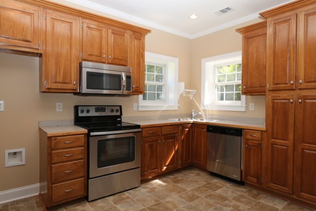 355 Bass Road Macon, GA 31210 - Photo 2 of 24 a kitchen with granite countertop wooden cabinets stainless steel appliances and a window