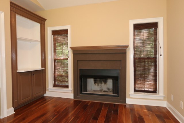 355 Bass Road Macon, GA 31210 - Photo 12 of 24 a view of an empty room with wooden floor fireplace and a window