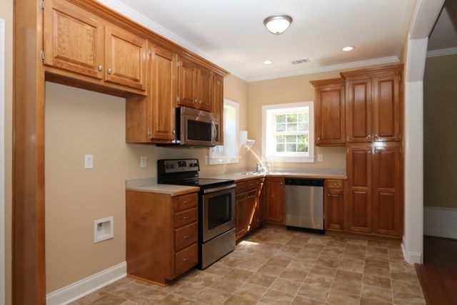 355 Bass Road Macon, GA 31210 - Photo 3 of 24 a kitchen with stainless steel appliances granite countertop a stove a sink and a microwave