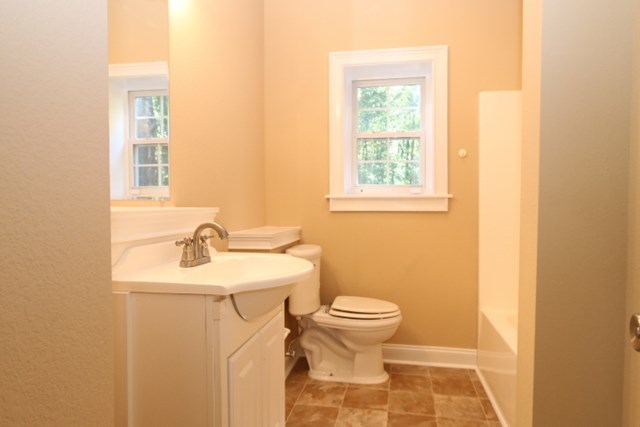 355 Bass Road Macon, GA 31210 - Photo 7 of 24 a bathroom with a sink toilet and a mirror