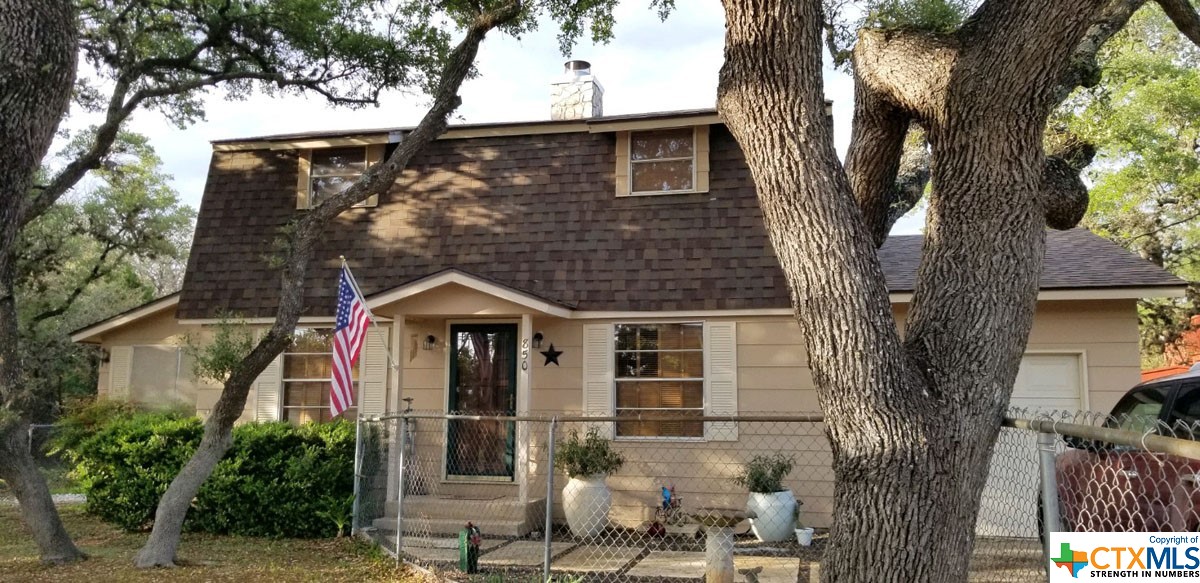 850 Riviera Drive Canyon Lake, TX 78133 - Photo 1 of 1 a front view of a house with garden