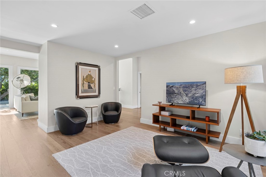 3 Rue Cannes Newport Beach, CA 92660 - Photo 12 of 46 Versatile living space ideal for a home office, media room, or additional lounge area with patio access and abundant natural light.