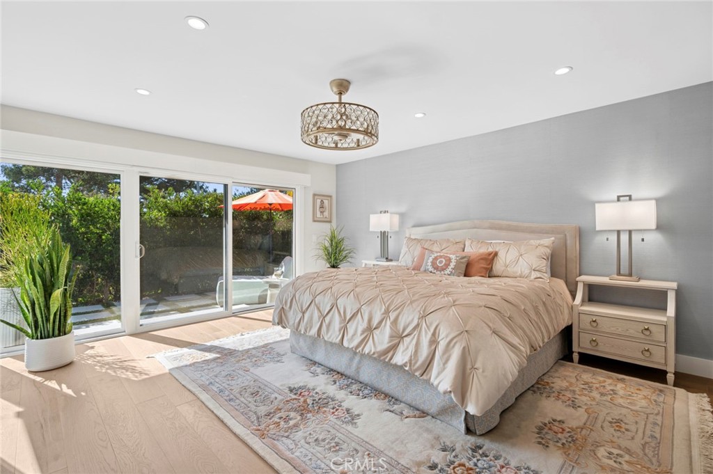 3 Rue Cannes Newport Beach, CA 92660 - Photo 14 of 46 Expansive primary suite filled with natural light, offering direct access to the private patio and peaceful garden views.