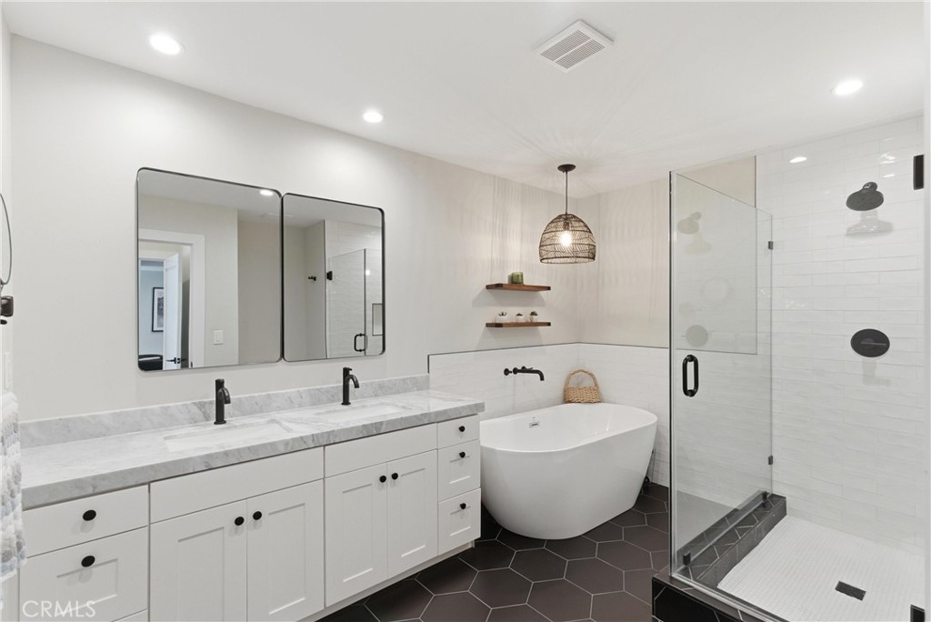 3 Rue Cannes Newport Beach, CA 92660 - Photo 16 of 46 Beautifully remodeled bathroom featuring marble-style counters, modern fixtures, and a shower/tub combination with contemporary tile finishes.