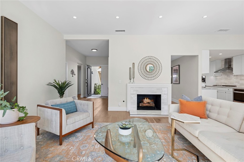 3 Rue Cannes Newport Beach, CA 92660 - Photo 2 of 46 Comfortable living room centered around a stylish fireplace, ideal for relaxing or entertaining guests.