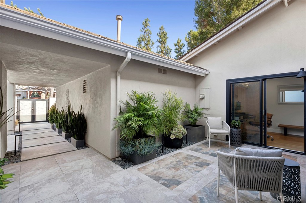 3 Rue Cannes Newport Beach, CA 92660 - Photo 23 of 46 Private courtyard and walkway connecting interior spaces while providing a peaceful, landscaped outdoor retreat.