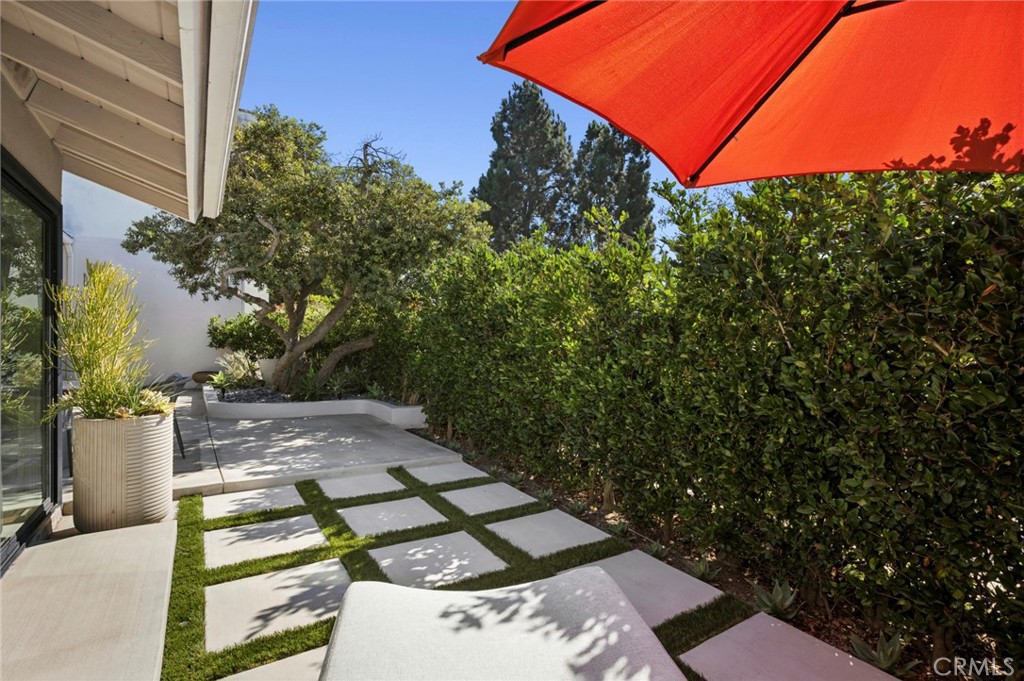 3 Rue Cannes Newport Beach, CA 92660 - Photo 27 of 46 Private backyard retreat featuring mature landscaping, custom hardscape, and spacious patio perfect for outdoor dining and entertaining.