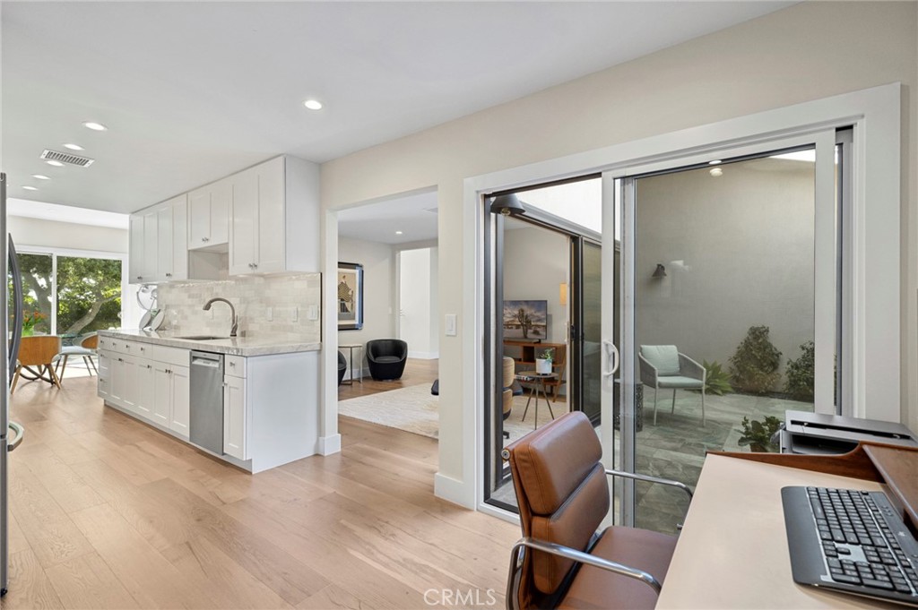 3 Rue Cannes Newport Beach, CA 92660 - Photo 10 of 46 Open kitchen layout flowing toward adjacent workspace and living areas, offering both functionality and modern design.