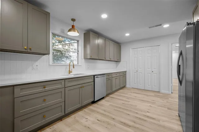 a kitchen with a sink cabinets and window