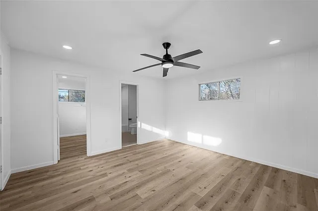 a view of empty room with wooden floor