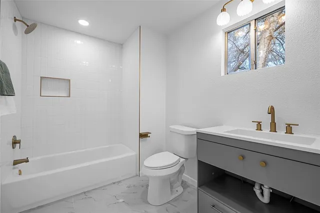 a bathroom with a toilet a sink and a bathtub