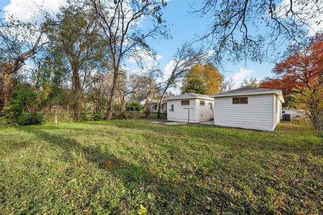 a view of a backyard with large trees