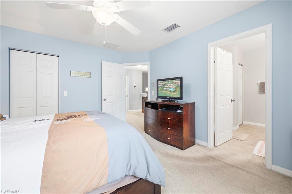 3916 Cherrybrook Loop Fort Myers, FL 33966 - Photo 14 of 31 Carpeted bedroom with a ceiling fan, light blue walls, and white bi-fold closet doors