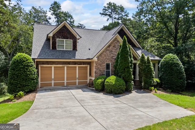 a kitchen with kitchen island granite countertop wooden floors and white cabinets