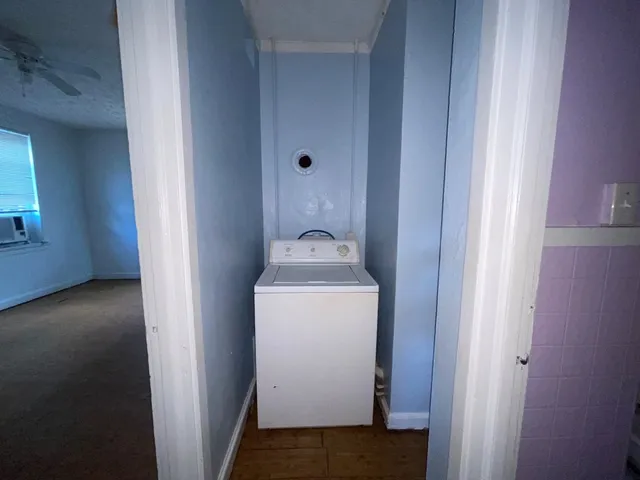 a utility room with washing machine