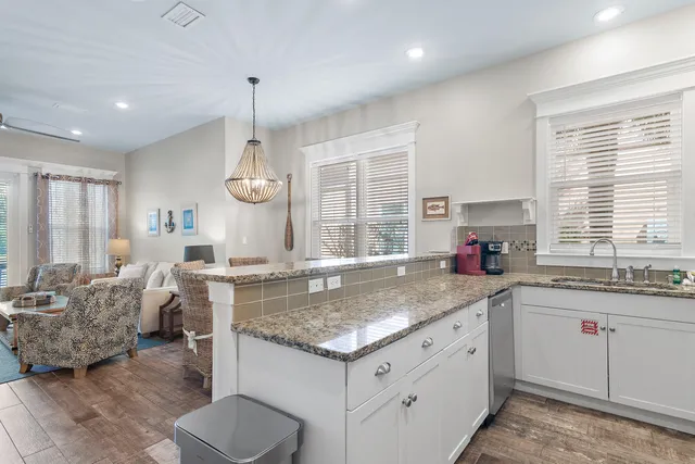a kitchen with stainless steel appliances granite countertop a sink and a granite counter tops