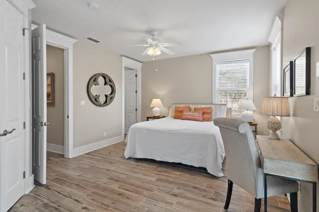 a bedroom with a bed mirror and a window
