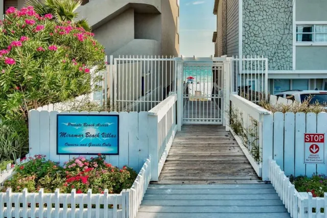 a view of a house with wooden fence