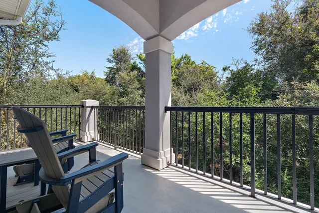 a view of balcony with wooden floor and outdoor seating