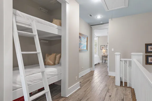 a hallway with wooden floor and furniture