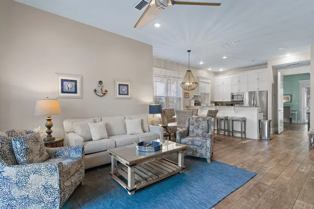 a living room with furniture and kitchen view