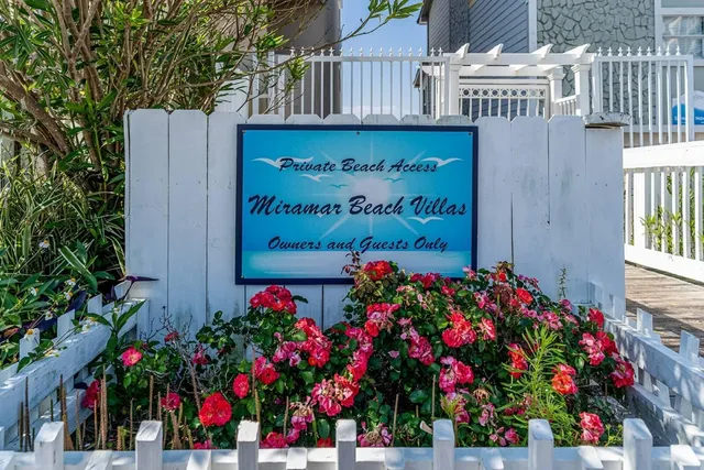 a sign that is in front of flowers