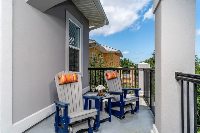 a outdoor sitting area with furniture and wooden floor