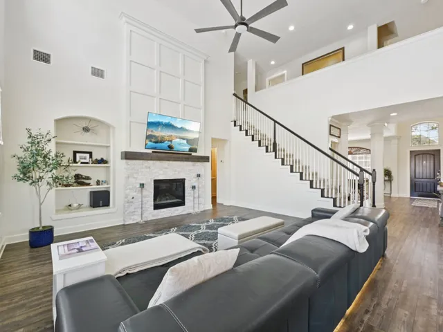 a living room with furniture and wooden floor