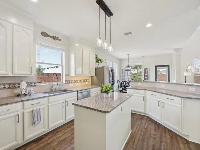 a kitchen with refrigerator a stove and wooden cabinets
