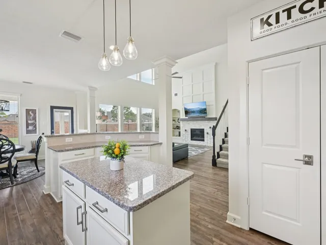 a kitchen with sink stove and cabinets