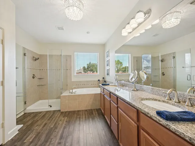 a bedroom with a large bed and a chandelier