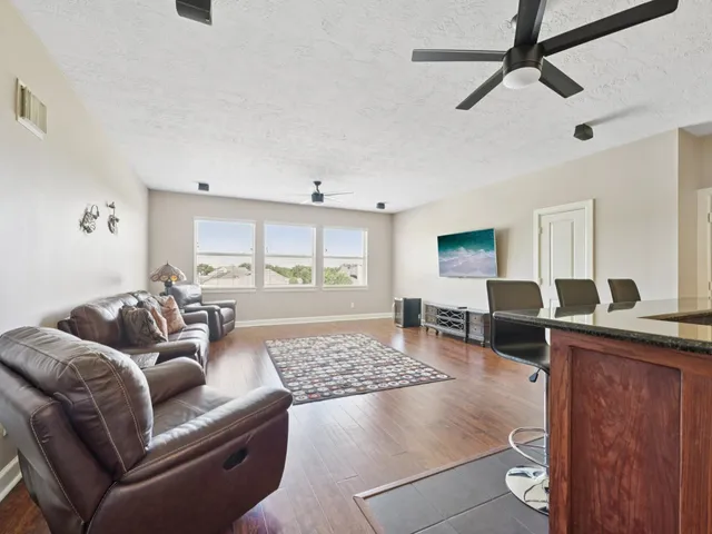 a bathroom with a granite countertop sink toilet and mirror