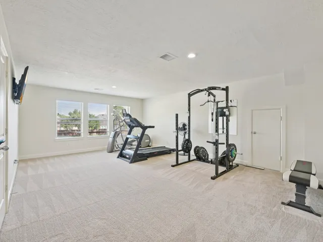 a bathroom with a granite countertop sink a toilet a mirror and shower curtain