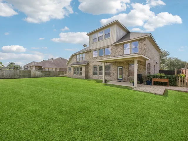 a bathroom with a granite countertop toilet a sink and mirror