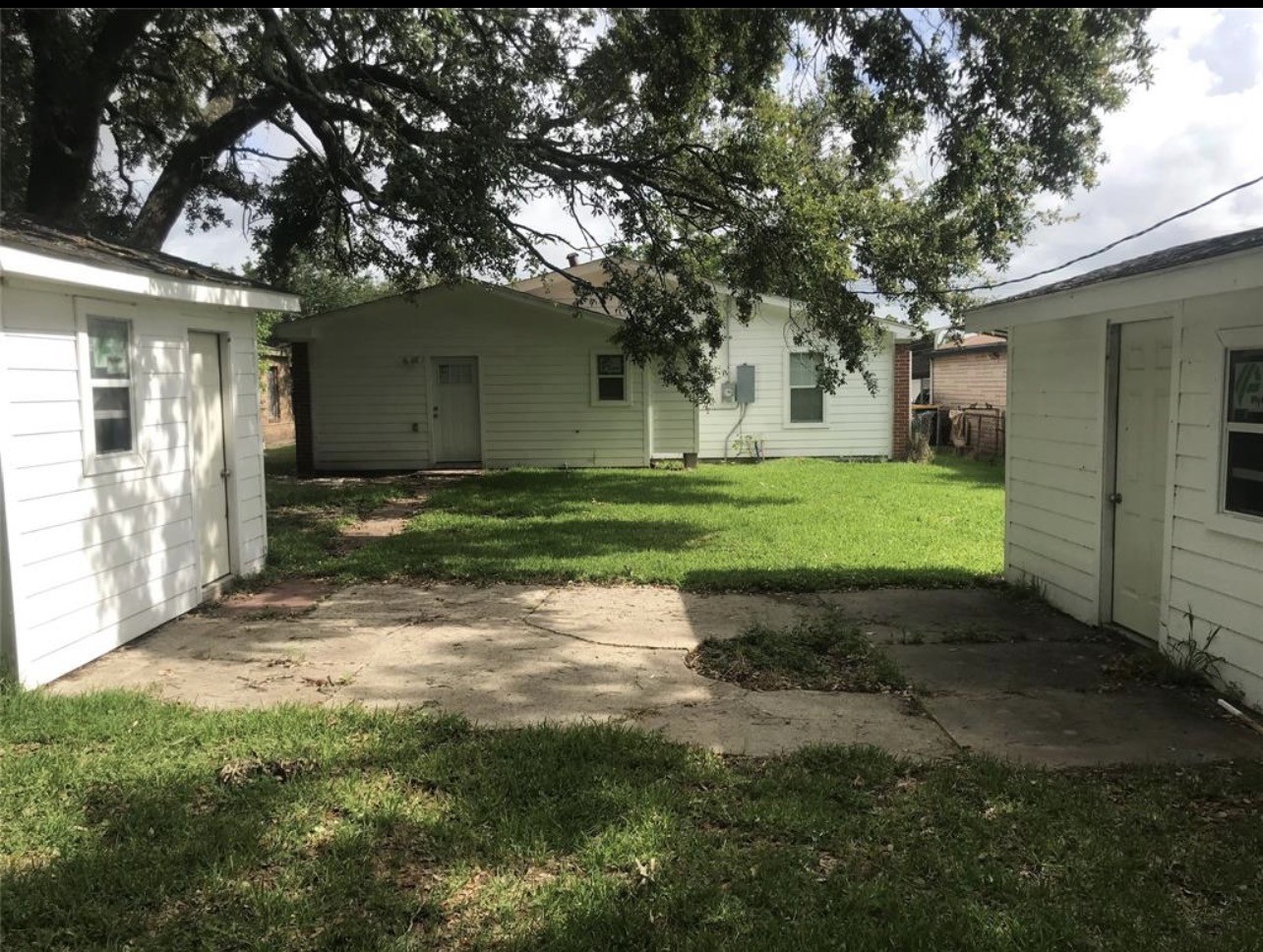 2515 Jackson La Marque, TX 77568 - Photo 16 of 19 a view of a yard in front of a house with large trees