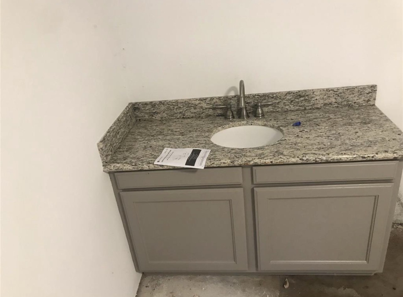 2515 Jackson La Marque, TX 77568 - Photo 17 of 19 a bathroom with a granite countertop sink and a mirror