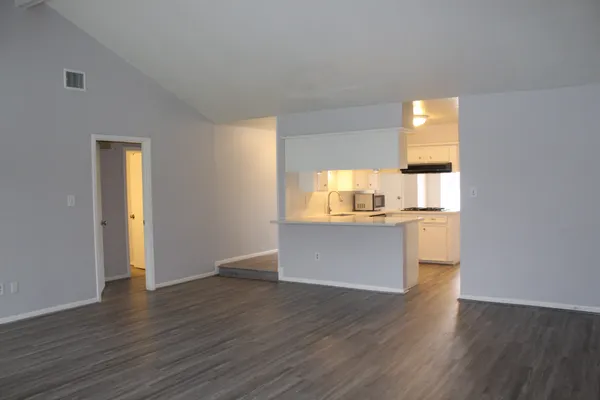 a view of kitchen with wooden floor and electronic appliances
