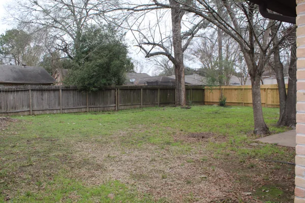 a backyard of a house with lots of green space