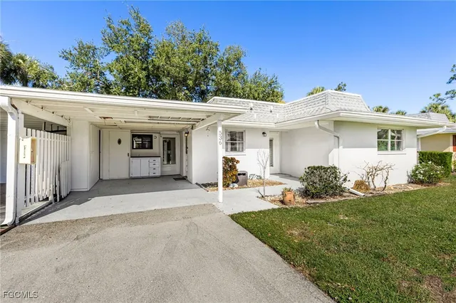 a front view of a house with yard and green space
