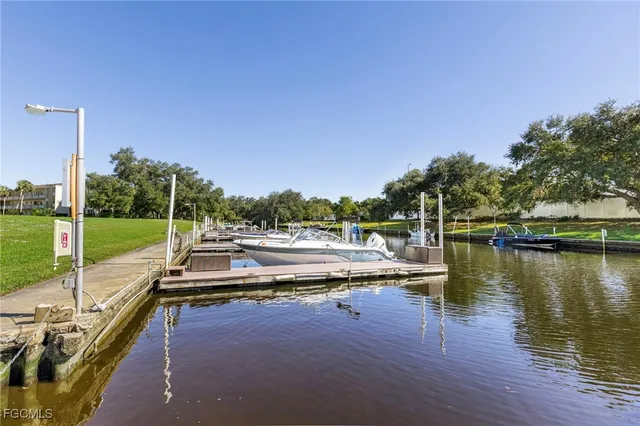 a view of a lake with a yard and a large window