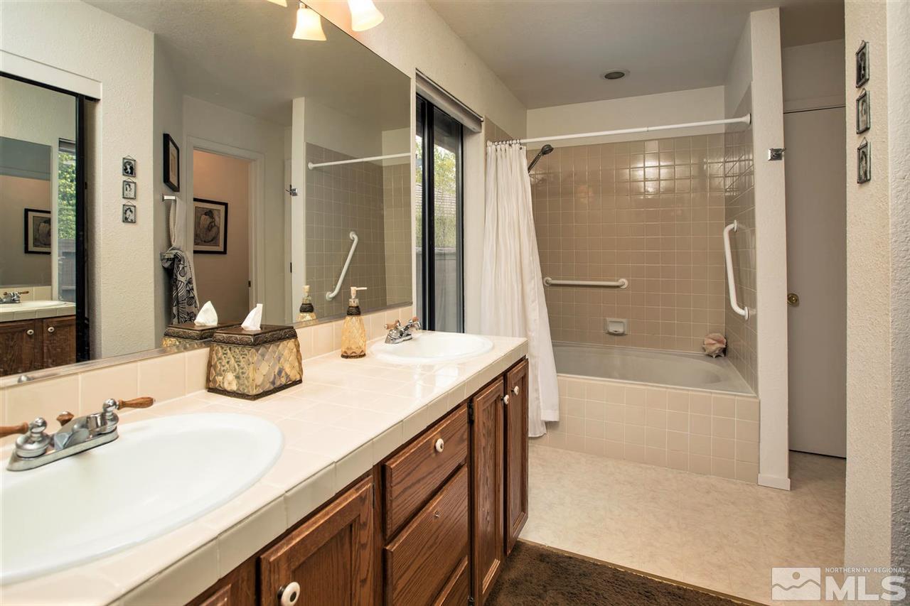 145 Riverhaven Place Reno, NV 89519 - Photo 13 of 23 a bathroom with a tub sink and mirror