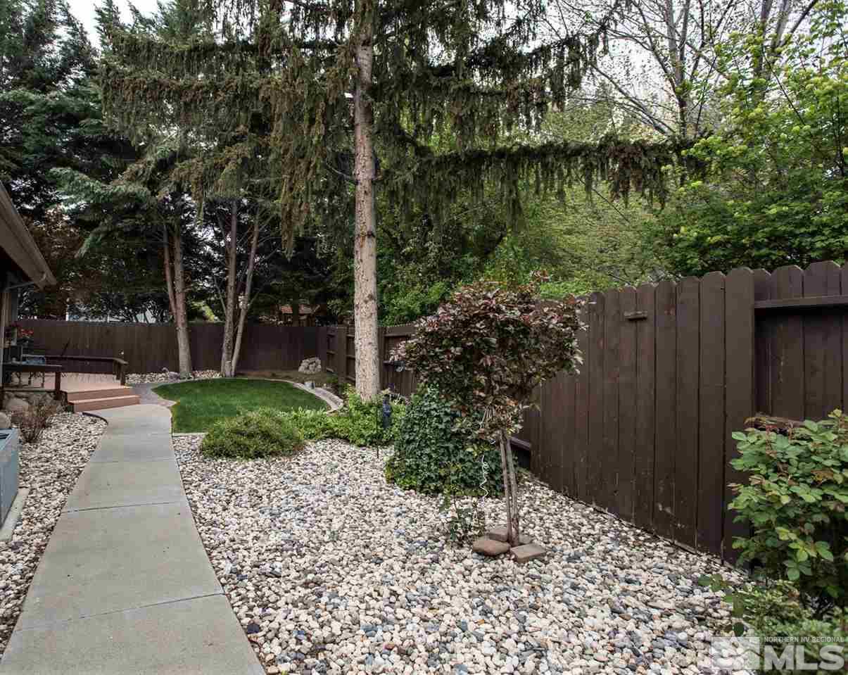 145 Riverhaven Place Reno, NV 89519 - Photo 22 of 23 a backyard of a house with lots of green space