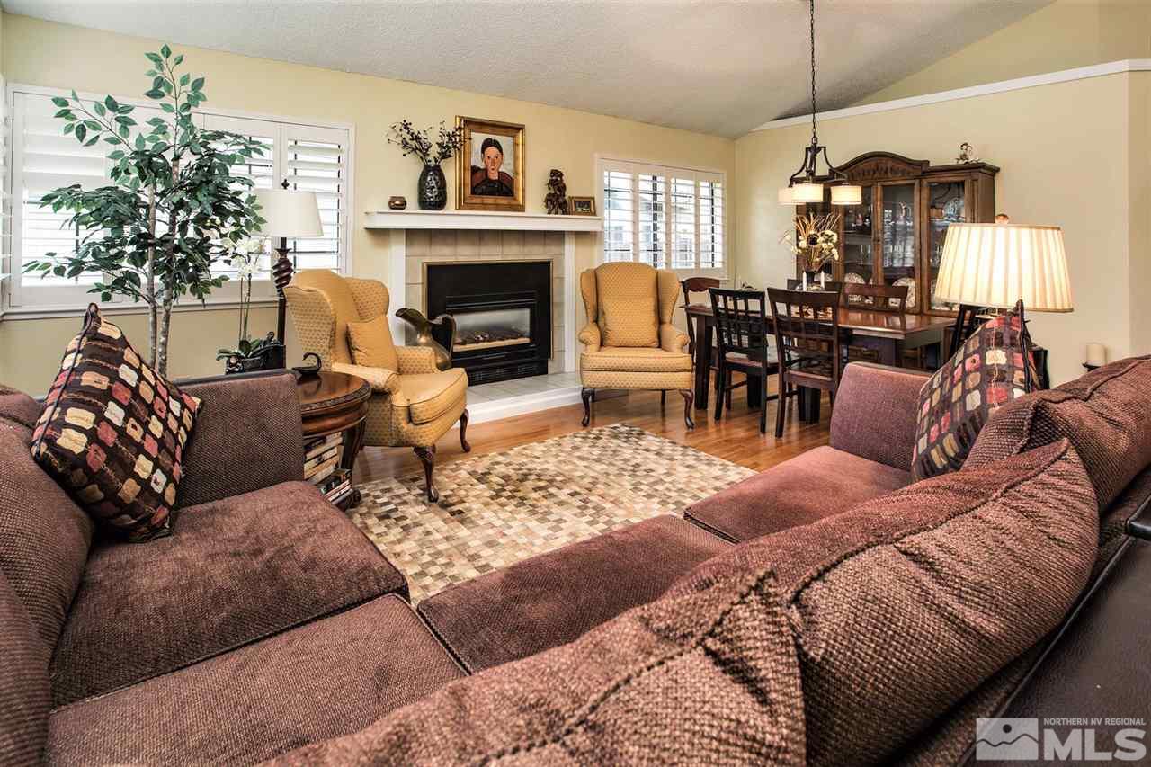 145 Riverhaven Place Reno, NV 89519 - Photo 3 of 23 a living room with furniture a fireplace and a chandelier