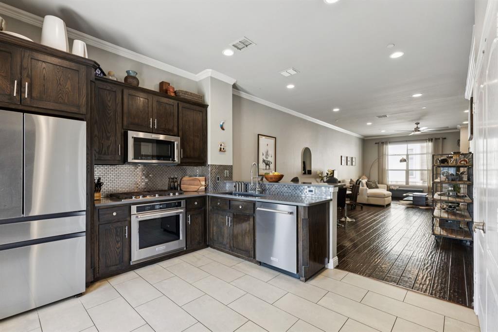 722 East 1st Street Fort Worth, TX 76102 - Photo 2 of 25 Such a beautiful kitchen, from the striking backsplash to the quartz countertops.