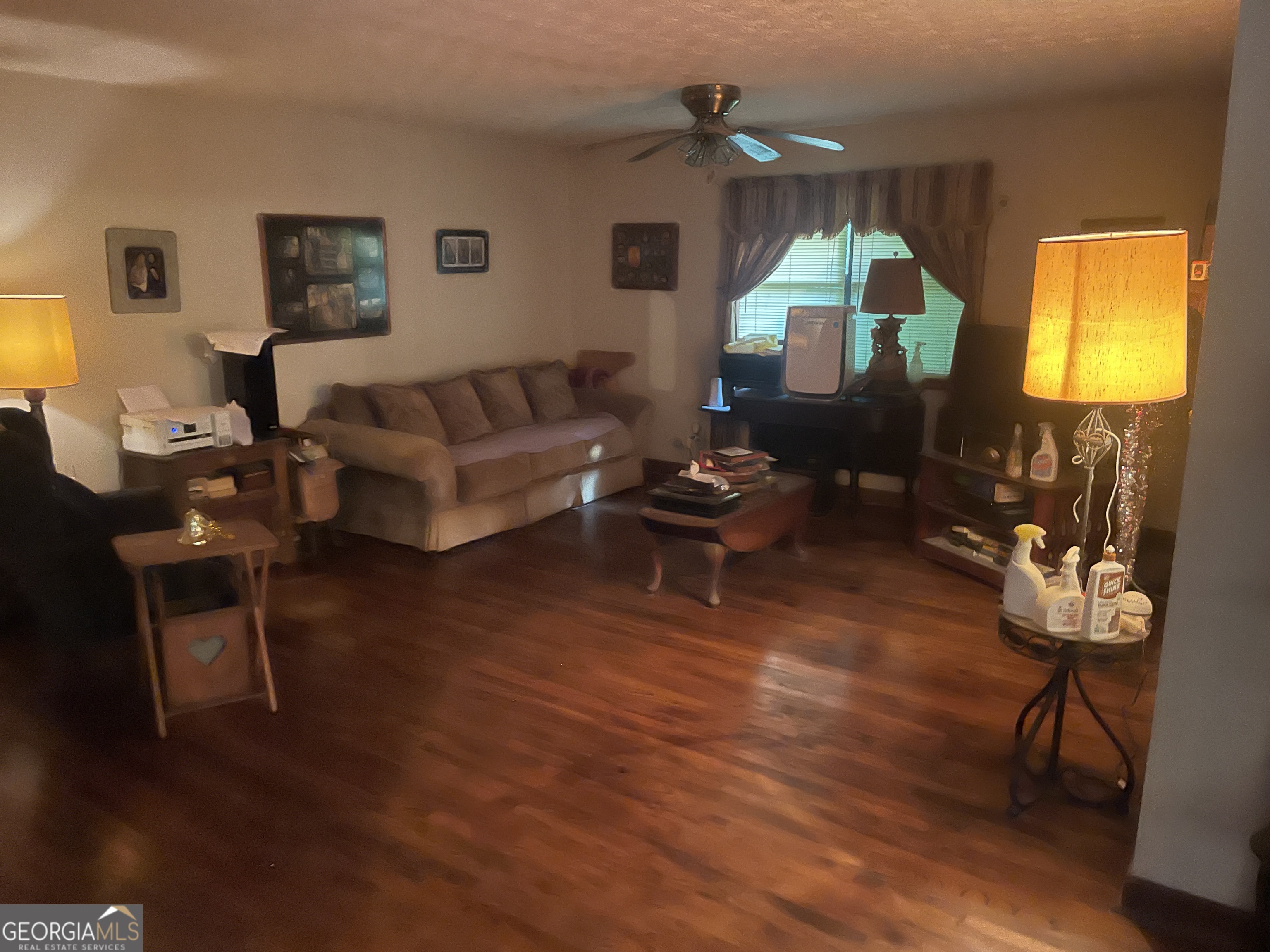 221 Oak Grove Road McDonough, GA 30253 - Photo 2 of 3 a living room with fireplace furniture and a wooden floor