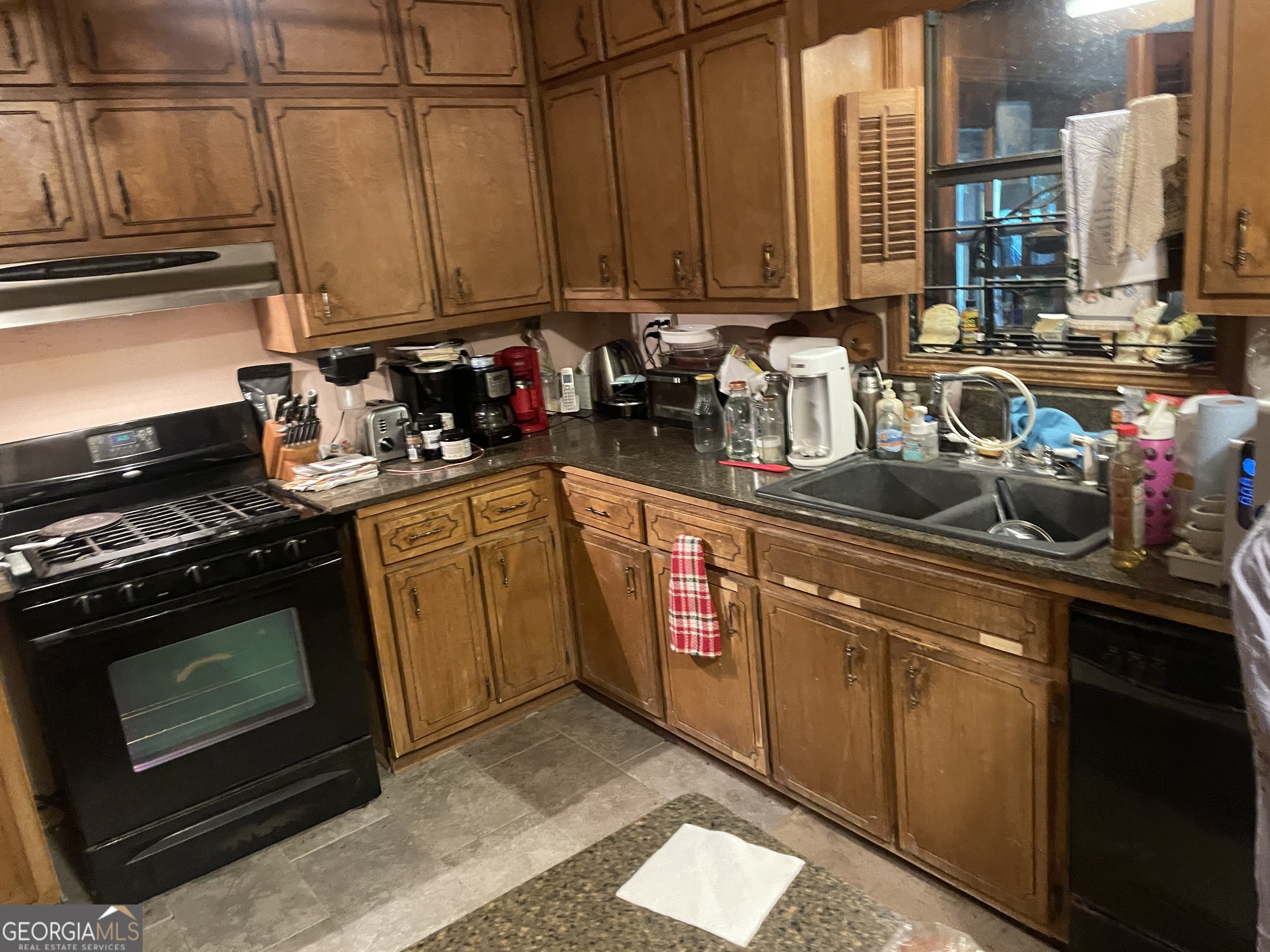 221 Oak Grove Road McDonough, GA 30253 - Photo 3 of 3 a kitchen with stainless steel appliances granite countertop a stove a sink and a microwave