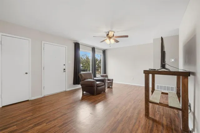 a view of a livingroom with furniture and hardwood floor