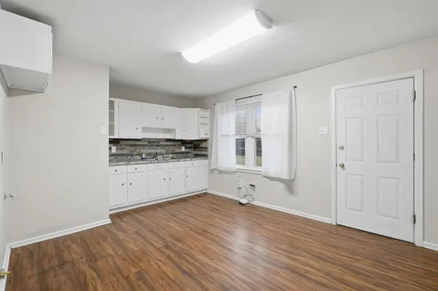 a view of kitchen with wooden floor and electronic appliances